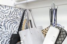 simple metal hooks in your closet or on some rails will hold all the bags that have any kind of handles