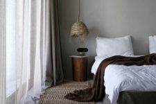 a wicker pendant lamp with fringe is a very rustic and coastal touch to the bedroom, a jute rug matches