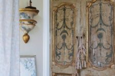 antique shabby doors spruced up with blue stencils that are repeated on furniture and lamps