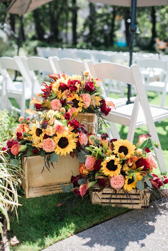 crates with bright fall blooms and foliage are great to decorate a rustic fall wedding