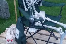 a fisherman skeleton in a chair plus a skeleton dog is a nice backyard decoration for Halloween