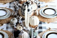 a gorgeous plaid fall tablescape with a plaid tablecloth, woven placemats, faux white and plaid pumpkins, cotton and antlers