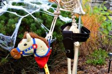 a hilarious cowboy skeleton in a hat with a fun horse is a whimsical and hilarious decoration for Halloween