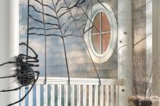a spiderweb with skeleton spiders is a nice scene for your Halloween front porch