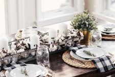 a stylish farmhouse fall tablescape with woven placemats, a cotton and candle centerpiece with greenery