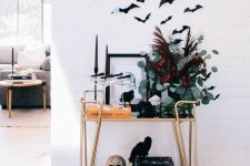 attach some bats over a fireplace or a bar cart to make it look Halloween-like