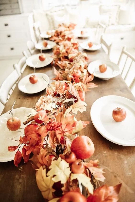 a cool fall table garland of leaves, apples of various sizes and cinnamon sticks is amazing for fall decor
