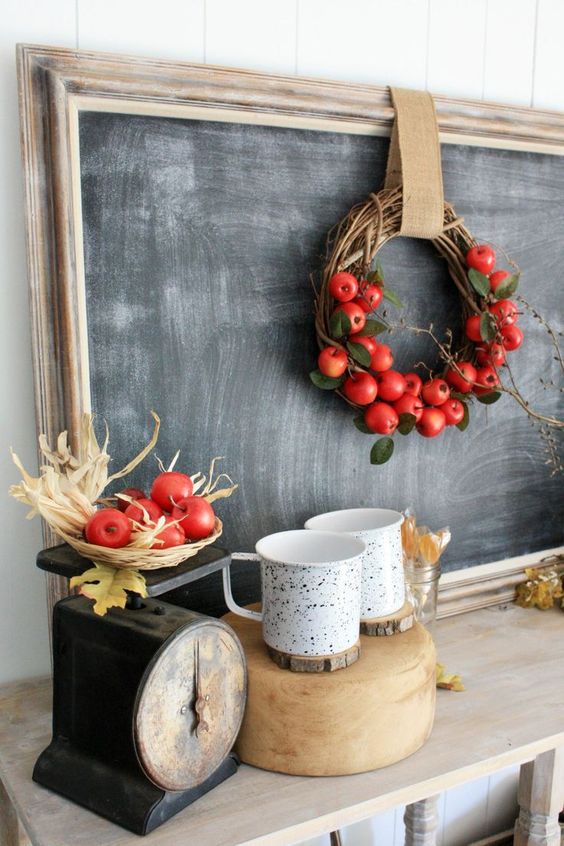 a vine wreath with foliage, red apples and a burlap ribbon is a bright and cool decoration to rock