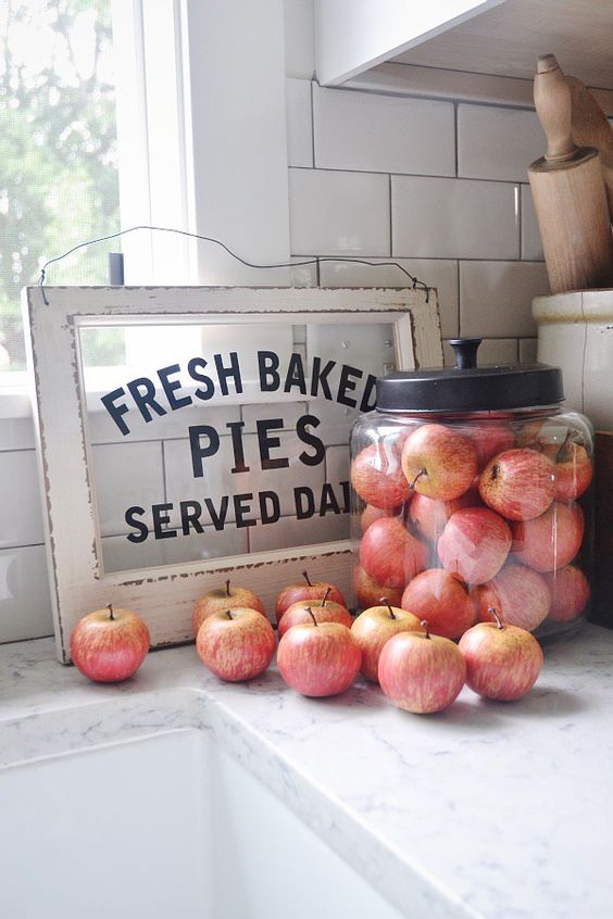 fresh apples in a large glass jar can be not only food but also a pretty farmhouse decorations for a fall space