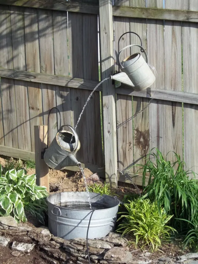 Water jug fountain. It's made of a bunch of galvanized water cans a galvanized water tub. (via dawnmarie100)