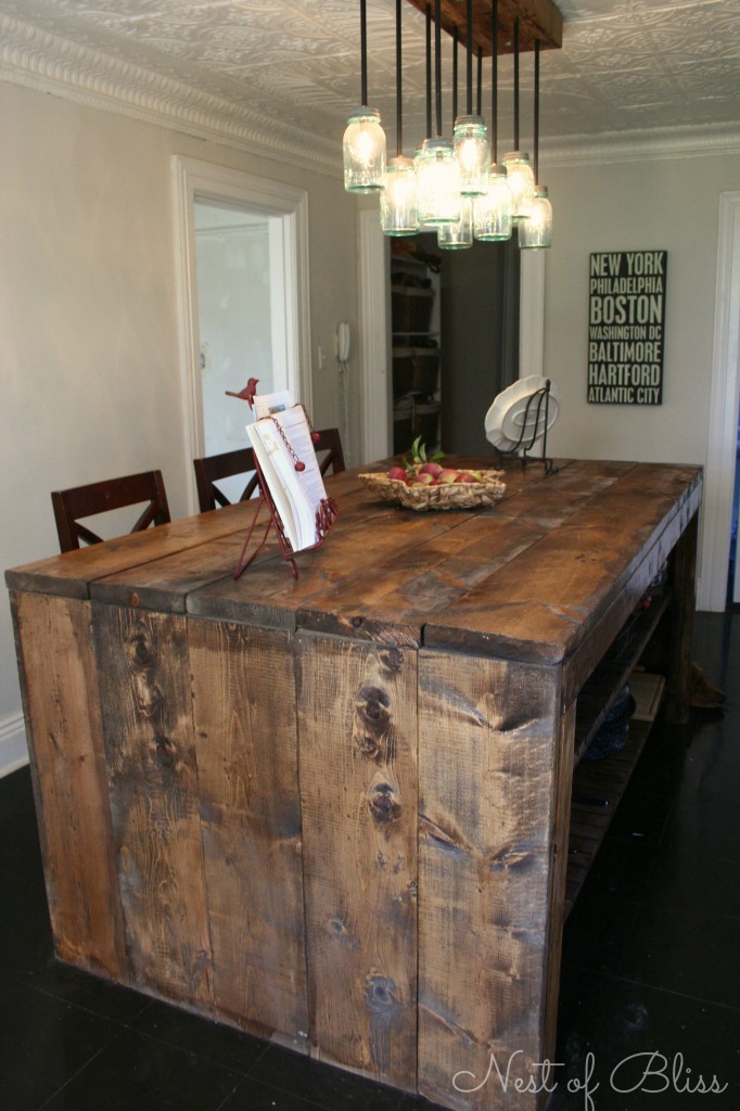 This awesome kitchen island was made from simple pine boards from Home Depot which were distressed. Make sure to choose the most scuffed up knotty wood you could. To distress it you need an old rusty chain.  Just toss, drop, and whip your chain everywhere. (via brandisawyer)