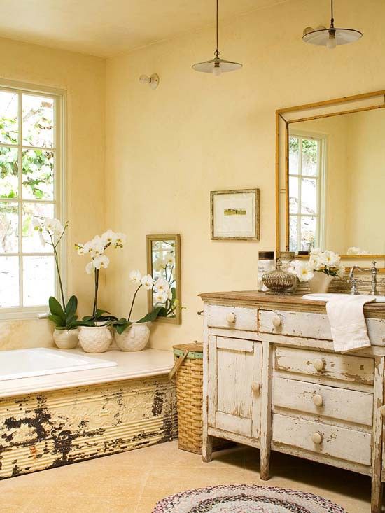 yellow shabby chic bathroom with potted orchids