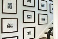a black and white grid gallery wall with black and white family pics is a cool and stylish idea that brings ultimate elegance