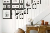 a free form black and white gallery wall with family and other photos is a cool solution for a modern space, and matching frames make it more cohesive