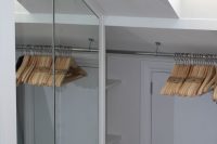 11 closet with mirror doors and clothes hangers