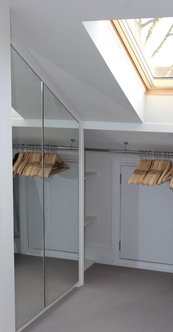 closet with mirror doors and clothes hangers