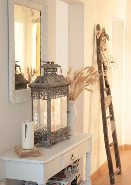 white entryway with wooden decor and a vintage metal lantern