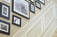 a free form black and white gallery wall with only family pics and black and white frames is a chic and stylish solution for a vintage space