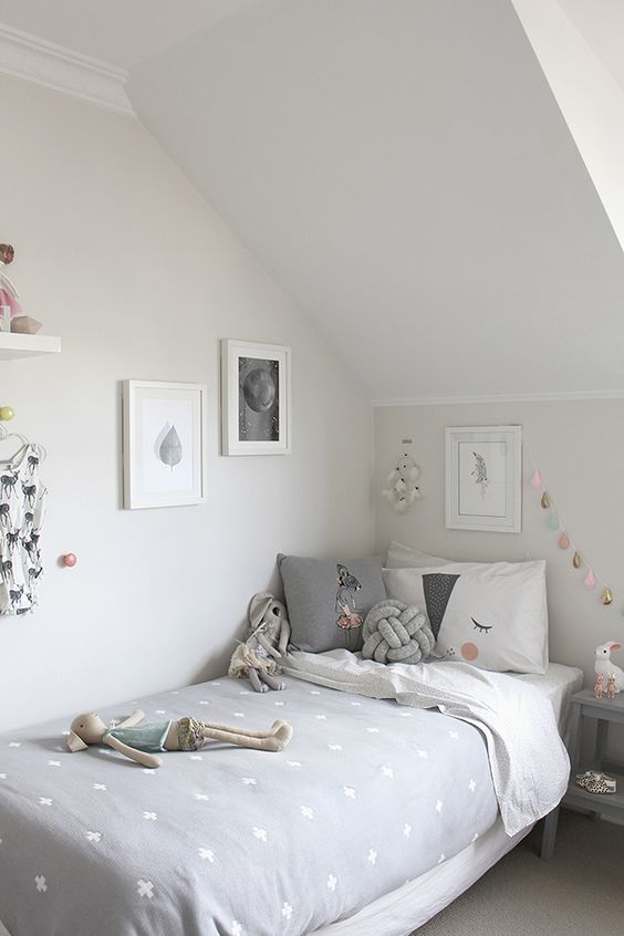 Scandinavian attic girl's room in grey and blush
