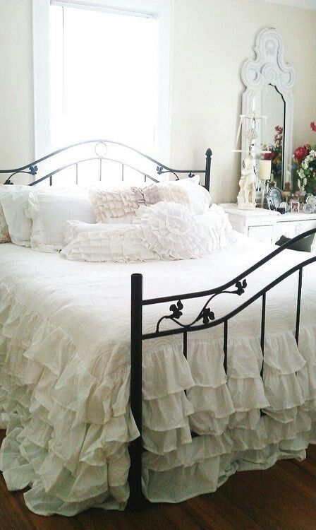 shabby chic bedroom with a black metal bed