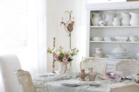 24 a crystal chandelier and a serenity ruffled tablecloth create an ambience