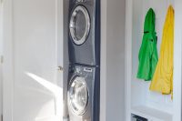 28 stacked washer and dryer in a mudroom laundry