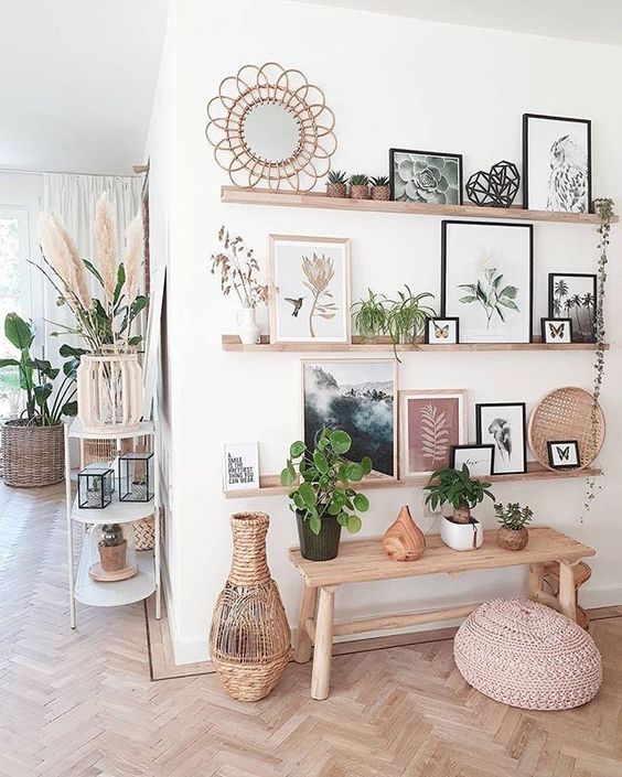 a boho space with stained ledges, artwork, potted plants and decor, a bench with plants and a woven vase