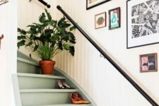 a bright and eclectic gallery wall with lots of fun art in mismatching frames is a cool idea for staircase decor