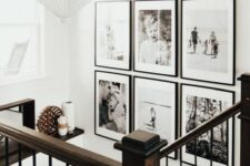 a chic black and white grid gallery wall with matching black frames and white matting adds style and a modern fele to the space