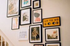 a chic gallery wall with black frames and abstract art and photos is a beautiful idea to spruce up a blank wall
