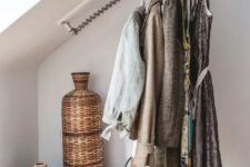 a cool attic storage idea – railing for clothes that makes your outfits part of your home decor or just saves space in the closet