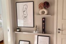 a cool gallery wall with ledges and artwork, photos, dried blooms and some decor is a cool decor idea for your home