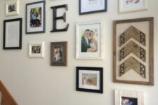 a cool rustic gallery wall with some family photos, quotes, an ampersand, monograms and wooden decor