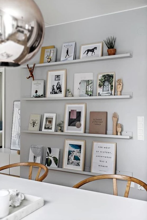 a dove grey wall with matching ledges that merge with the wall and make all the objects on display floating in the air