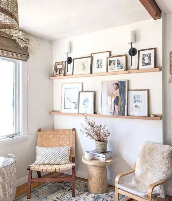 a farmhouse gallery wall with stained wooden ledges, colorful artworks and family makes the space more welcoming and cozy