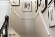 a free form gallery wall with matching black frames and black and white family pics is a lovely and artsy way to display the photos