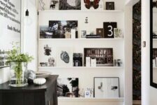 a large ledge gallery wall from floor to ceiling, with black and white and colored artwork and photos is a cool idea