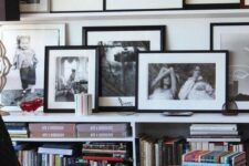 a ledge with black and white artworks and a second row on a bookcase allow displaying the photos not too high