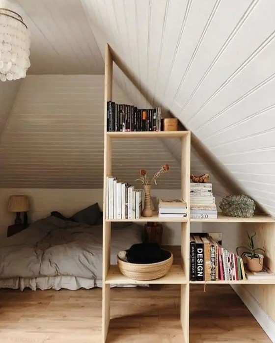 a lovely stained storage shelf that doubles as a space divider is a cool idea for an attic space, it looks lovely