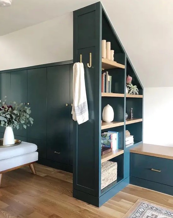 a navy attic storage unit that doubles as a space divider is a creative and stylish solution to divide zones in an open layout