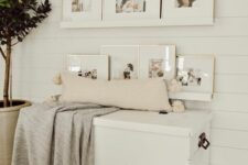 a paceful nook with neutral ledges and family photos, a white chest that doubles as a bench, a pillow and a blanket