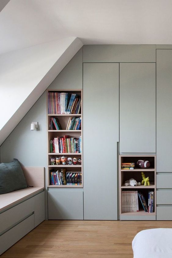 a sage green attic space with open niches and closed storage compartments is a lovely idea for storage