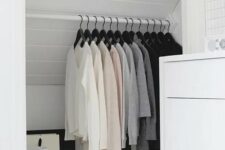 a smart and cool attic storage space turned into a closet with a holder for clothes hangers is a lovely idea