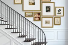 a sophsisticated gallery wall of artwork in gold frames composed in a free-form cluster is a chic decor idea for an entryway