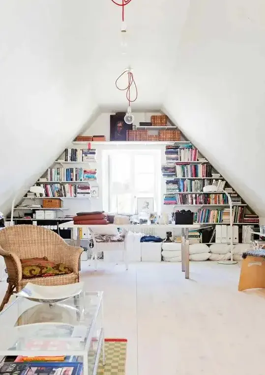 a stylish eclectic home office with built-in shelves, a desk, pillows, chairs, a bech and a glass coffee table plus cool ceiling and floor lamps