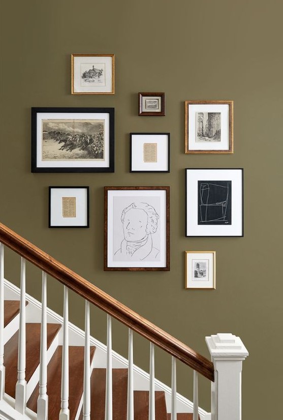 a vintage gallery wall with mismatching frames and artworks, black and white ones for a stylish look