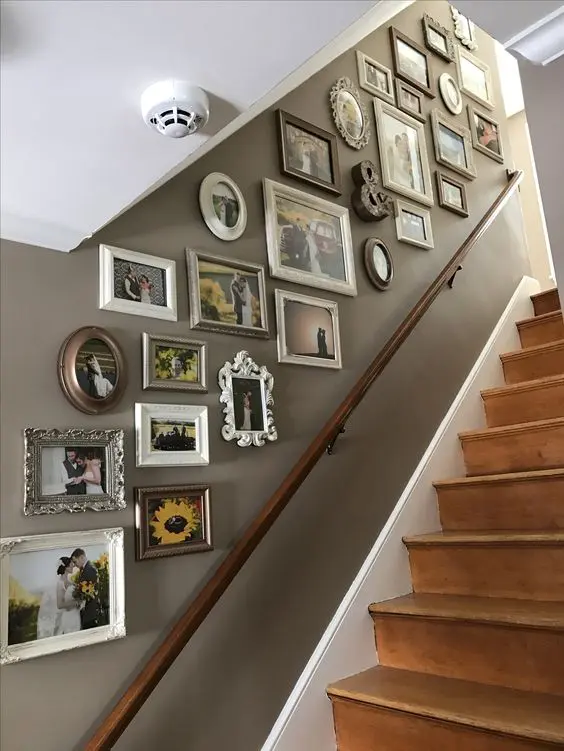 a vintage gallery wall with mismatching frames, photos, art and various types of decor added