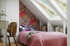 an attic bedroom with skylights, built-in bookshelves, a bed and a mirror desk plus a chair is a welcoming space