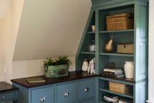 an attic nook with a blue dresser and a storage unit, with baskets and plants is an amazing and chic space