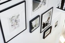 an elegant black and white gallery wall with photos and art plus black and white frames is a gorgeous idea for your space